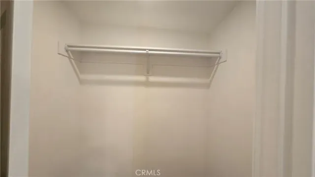 a view of a room with wooden floor and a ceiling fan