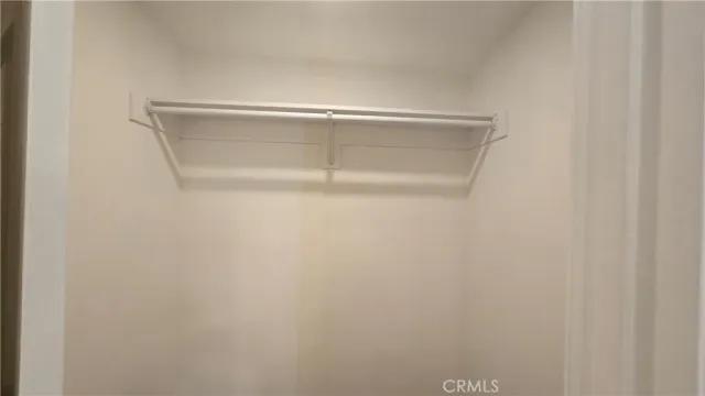 a view of a room with wooden floor and a ceiling fan