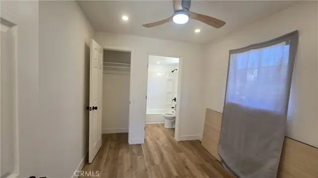 a bathroom with a granite countertop sink mirror bathtub and toilet