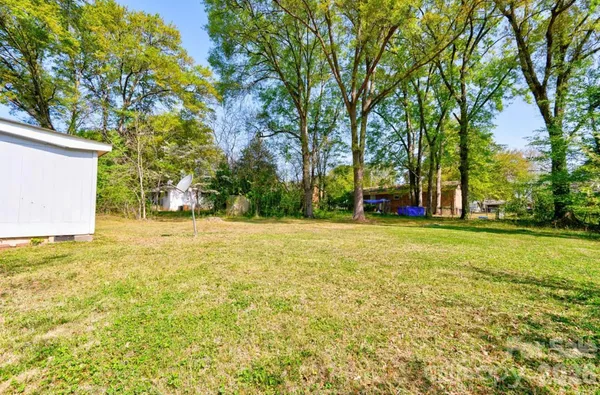 a view of outdoor space with garden and trees