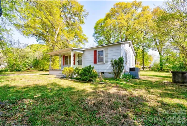a view of backyard of house with green space
