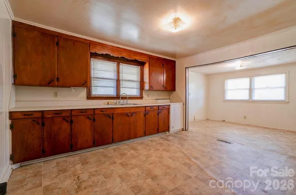 a kitchen with stainless steel appliances kitchen island granite countertop a stove a sink and a microwave