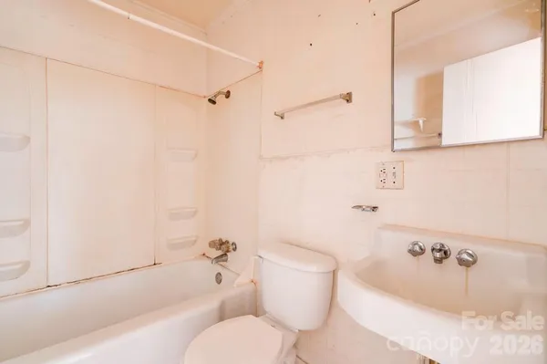 a bathroom with a bathtub toilet and sink