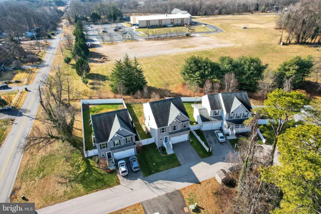 a view of swimming pool with lawn chairs and plants