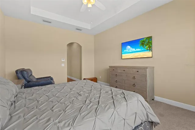 a bedroom with a bed and a painting on the wall