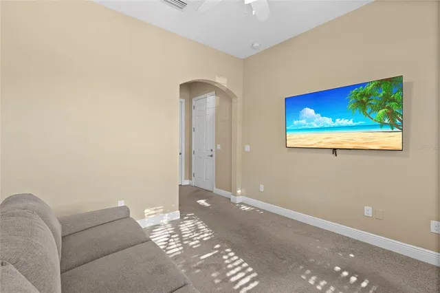 a living room with furniture and a wall