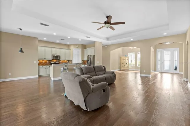 a living room with furniture and kitchen view