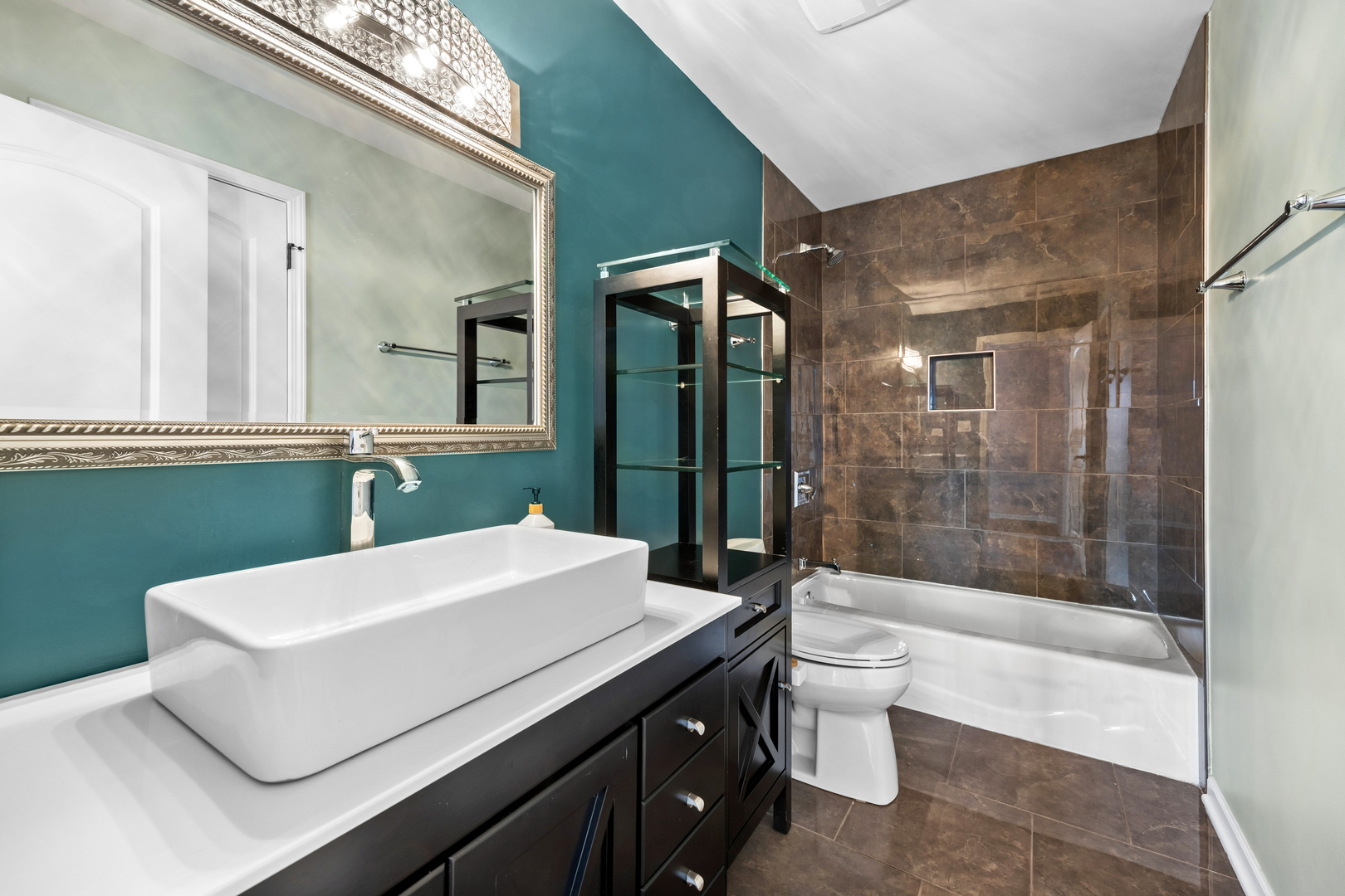 4103 Wisconsin Avenue Stickney, IL 60402 - Photo 13 of 24 a bathroom with a sink a toilet a mirror and shower