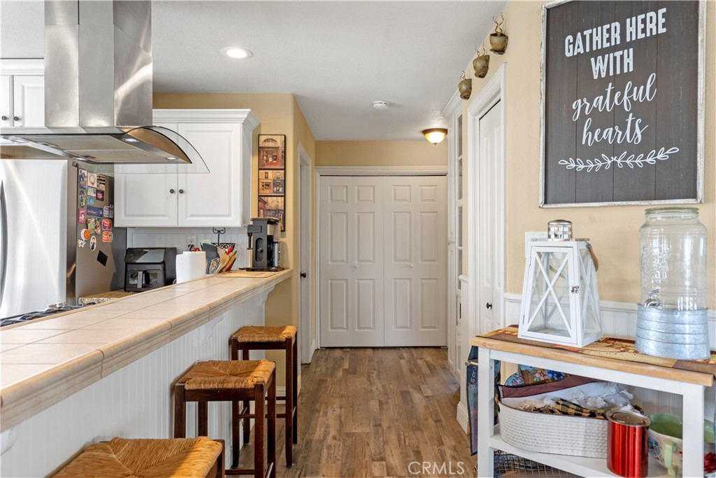 28841 Delaware Drive Tehachapi, CA 93561 - Photo 10 of 36 a view of a kitchen area with furniture and wooden floor
