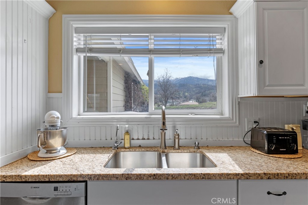 28841 Delaware Drive Tehachapi, CA 93561 - Photo 12 of 36 a kitchen with granite countertop a sink and a window