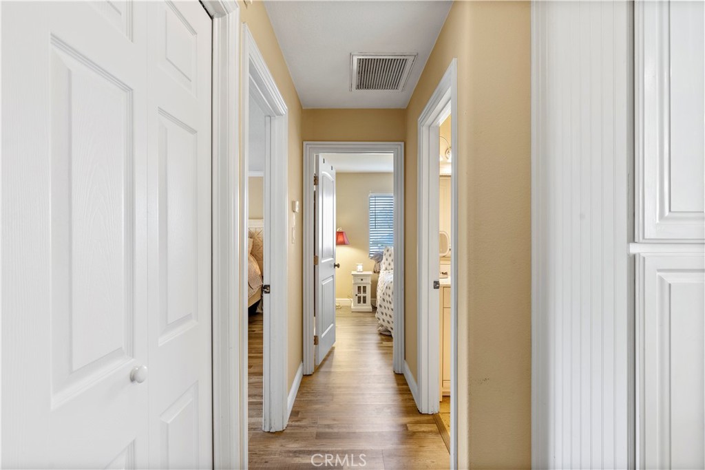 28841 Delaware Drive Tehachapi, CA 93561 - Photo 17 of 36 a view of a hallway with wooden floor and a bathroom
