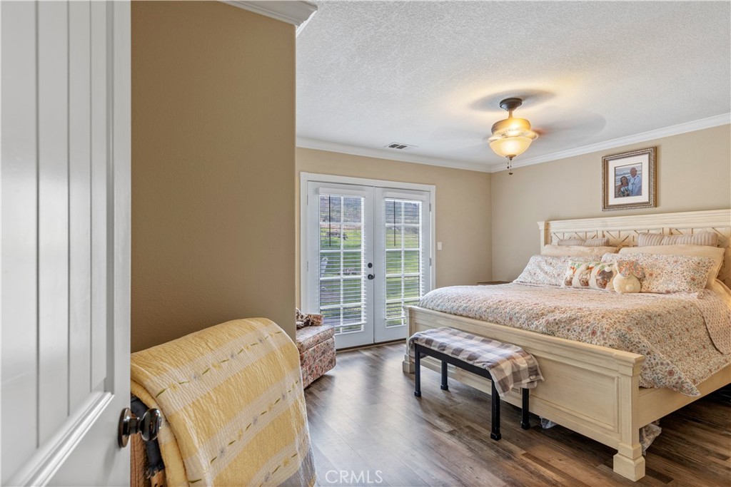 28841 Delaware Drive Tehachapi, CA 93561 - Photo 19 of 36 a bedroom with a bed and wooden floor