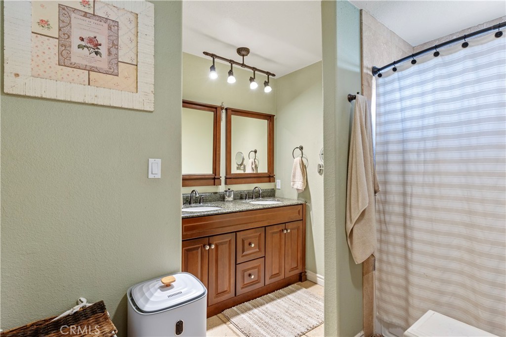 28841 Delaware Drive Tehachapi, CA 93561 - Photo 20 of 36 a bathroom with a granite countertop toilet sink and shower
