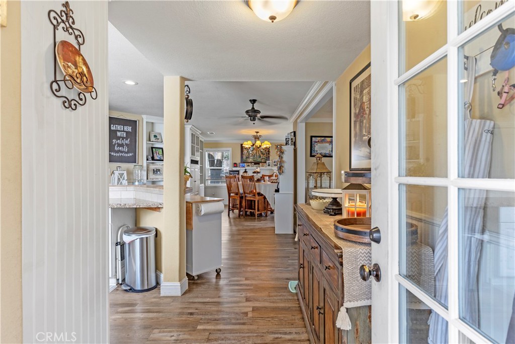 28841 Delaware Drive Tehachapi, CA 93561 - Photo 5 of 36 a view of a hallway with wooden floor and windows