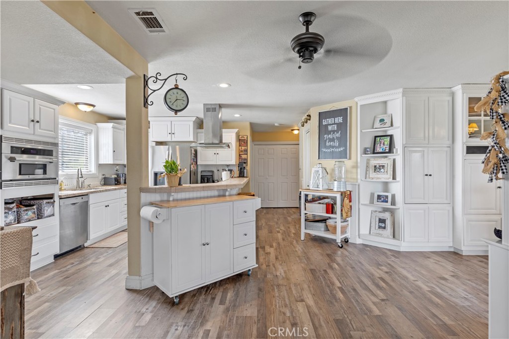28841 Delaware Drive Tehachapi, CA 93561 - Photo 6 of 36 a kitchen with stainless steel appliances a stove top oven and cabinets