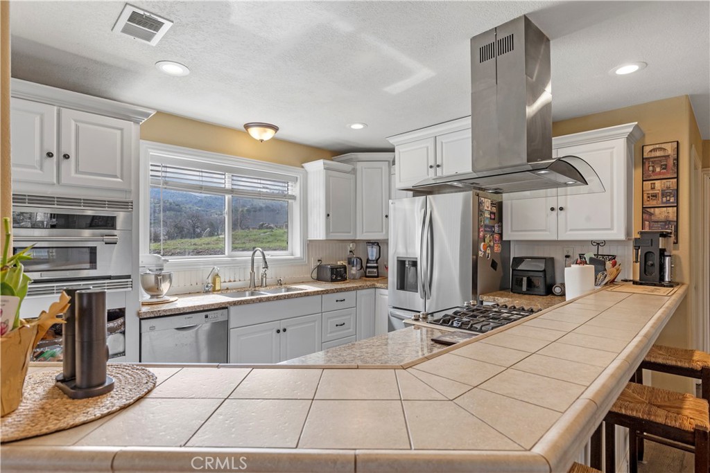 28841 Delaware Drive Tehachapi, CA 93561 - Photo 9 of 36 a room with gym equipment and stainless steel appliances