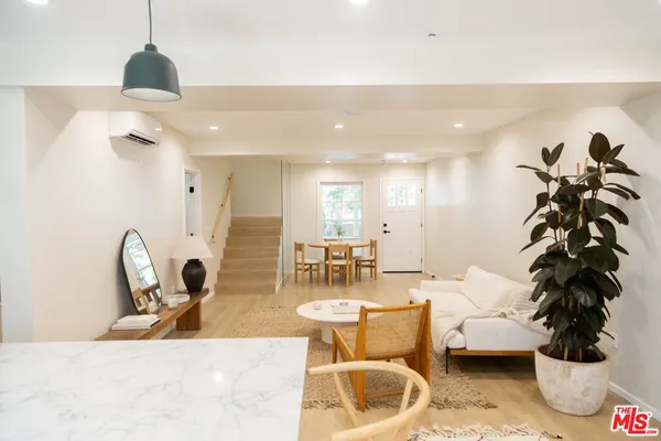 a living room with furniture and a chandelier