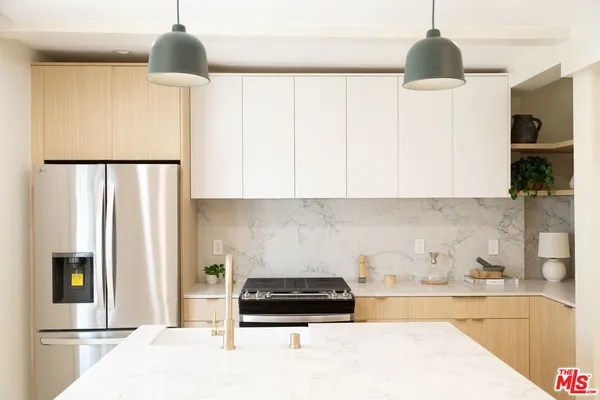 a kitchen with a stove and a refrigerator