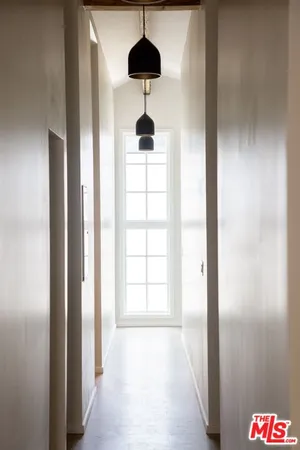 a bathroom with a chandelier and a wooden floor
