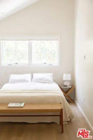 a spacious bedroom with a bed and a window
