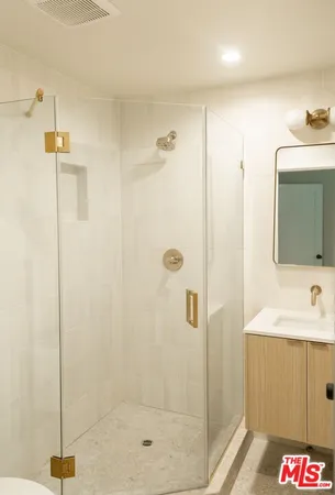 a bathroom with a shower and a sink