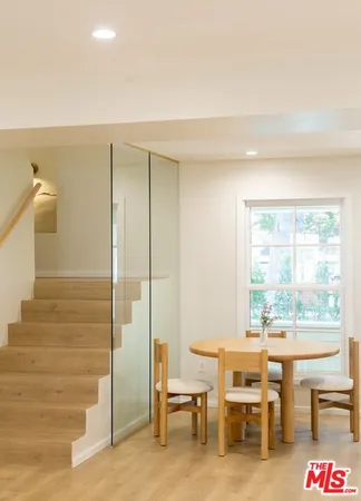 a view of a livingroom with furniture and staircase