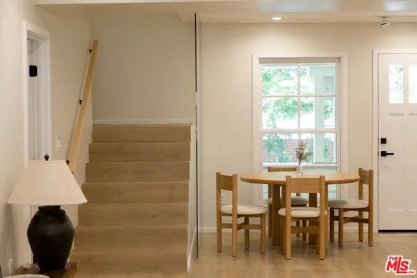 a view of a dining room with furniture and a window