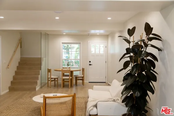a living room with furniture and a potted plant