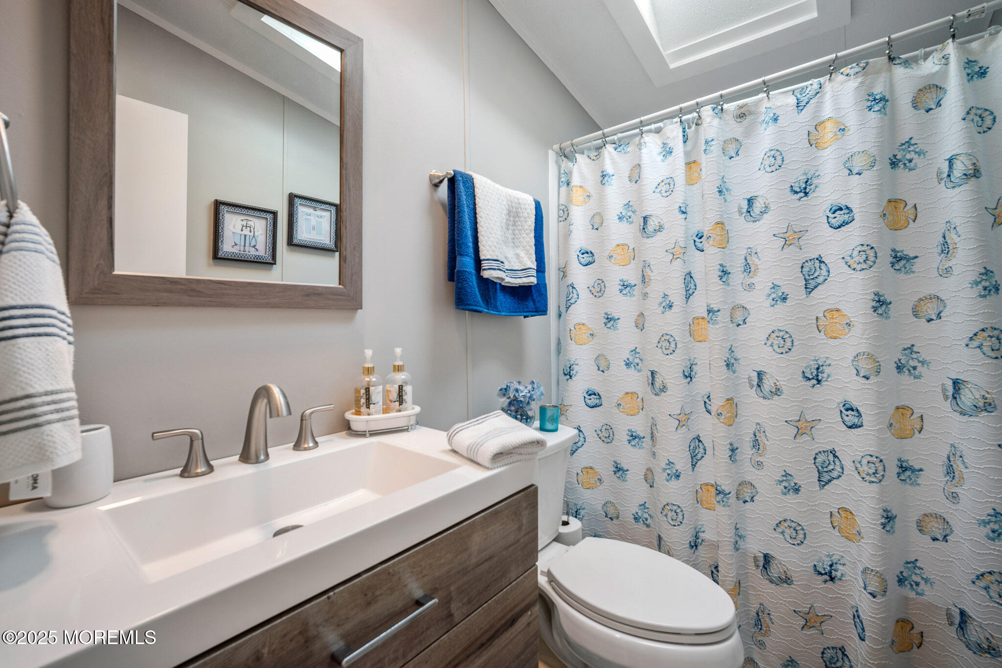 4 Oak Tree Lane Manahawkin, NJ 08050 - Photo 13 of 16 a bathroom with a sink a toilet and shower curtain