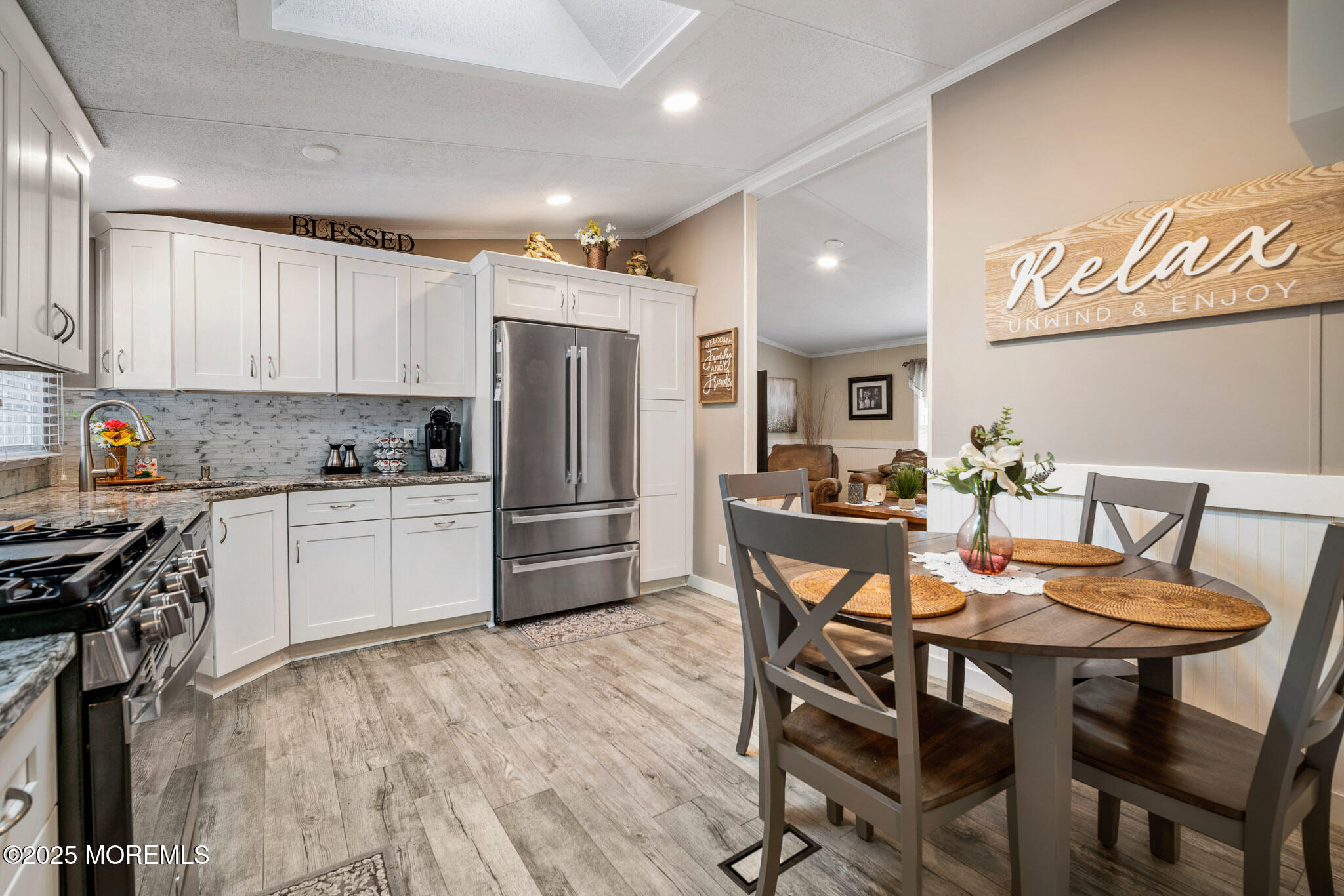 4 Oak Tree Lane Manahawkin, NJ 08050 - Photo 2 of 16 a kitchen with stainless steel appliances a refrigerator a stove a dining table and chairs