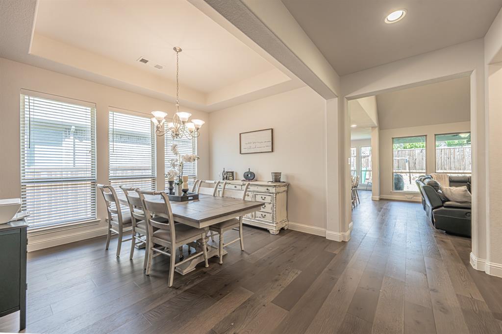 1610 Gardenia Street Prosper, TX 75078 - Photo 14 of 36 a view of a dining room with furniture window and wooden floor