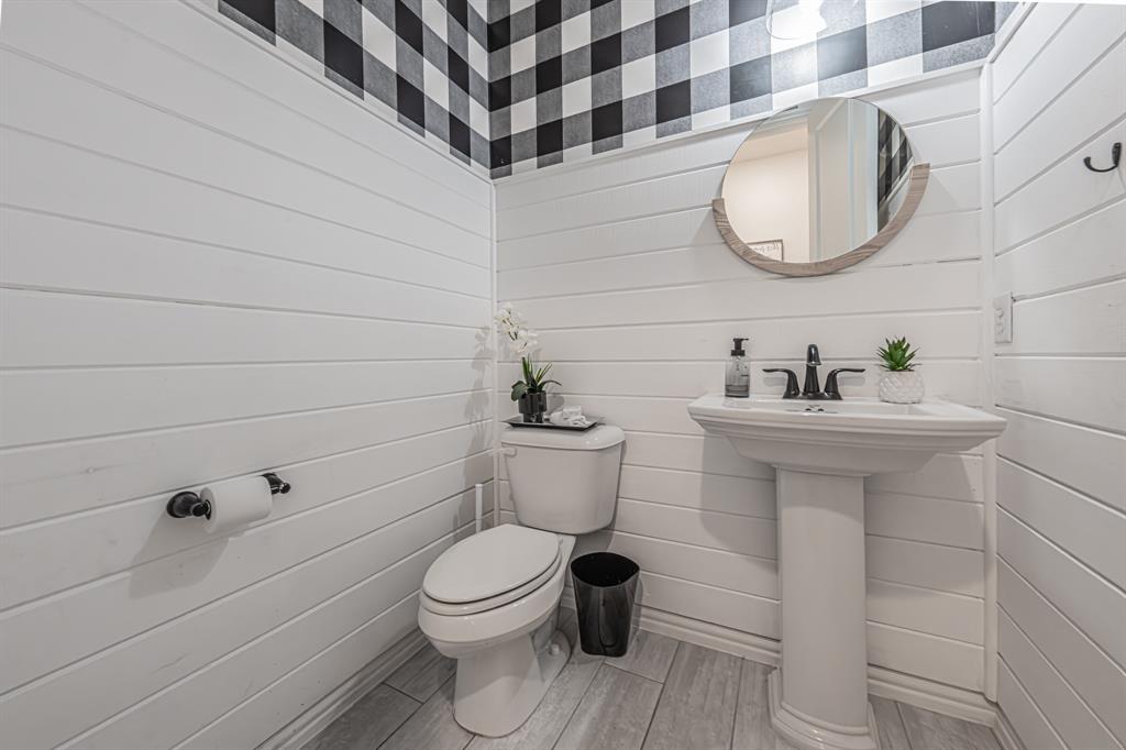 1610 Gardenia Street Prosper, TX 75078 - Photo 17 of 36 a bathroom with a toilet sink and mirror