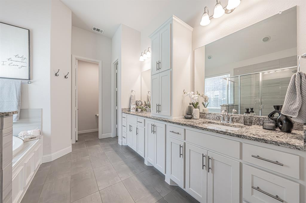 1610 Gardenia Street Prosper, TX 75078 - Photo 20 of 36 a spacious bathroom with double sink and a mirror