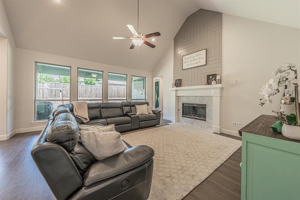 1610 Gardenia Street Prosper, TX 75078 - Photo 5 of 36 a living room with furniture and a fireplace