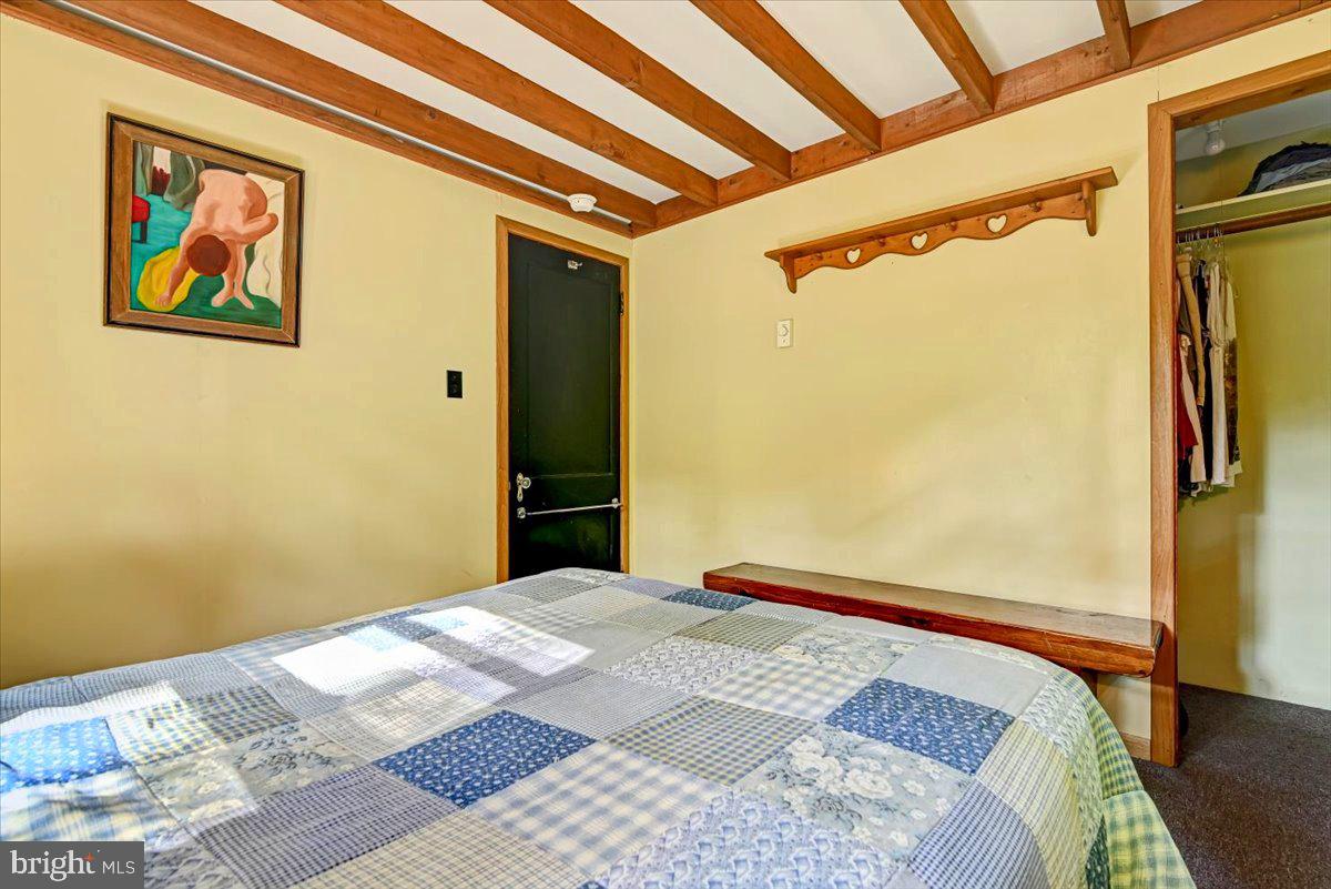 112 Beechwood Cove Road Greentown, PA 18426 - Photo 17 of 59 a bedroom with a large bed and a painting on the wall