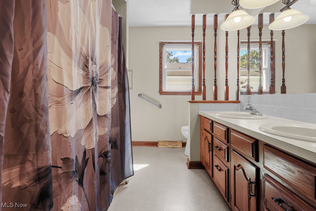1702 Far View Road Akron, OH 44312 - Photo 23 of 49 Full bath featuring double vanity and a shower with curtain
