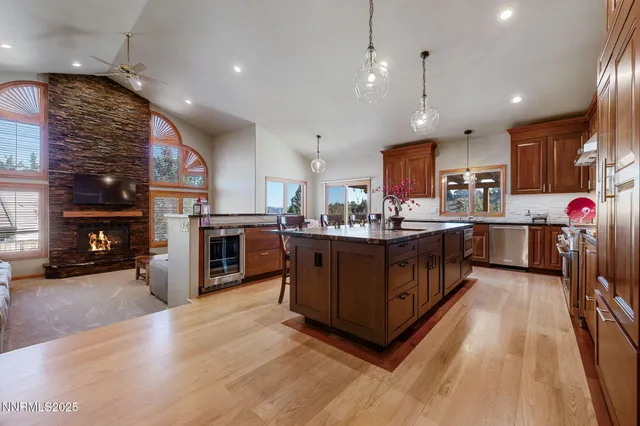 a living room with furniture a fireplace and a chandelier