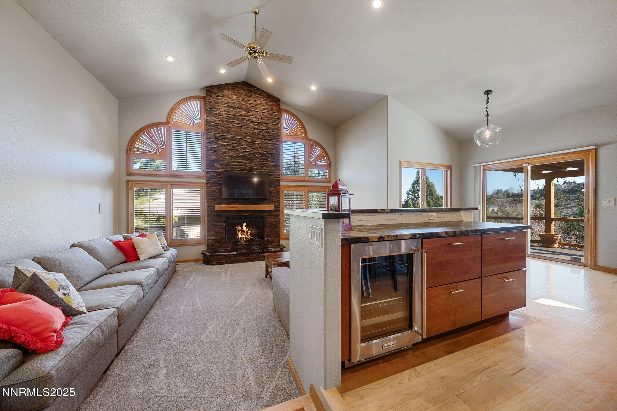 1205 Greensburg Circle Reno, NV 89509 - Photo 16 of 41 a living room with furniture a fireplace and a chandelier