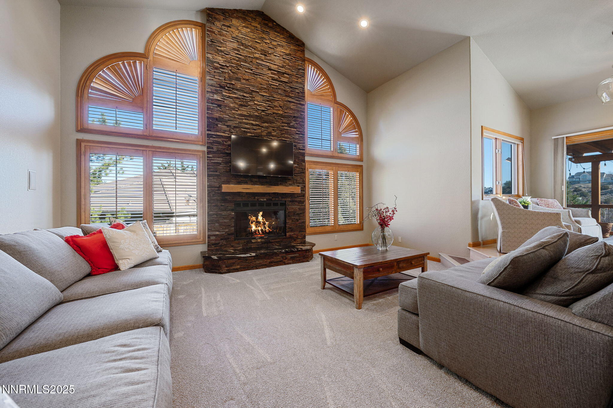 1205 Greensburg Circle Reno, NV 89509 - Photo 17 of 41 a living room with furniture a fireplace and a large window