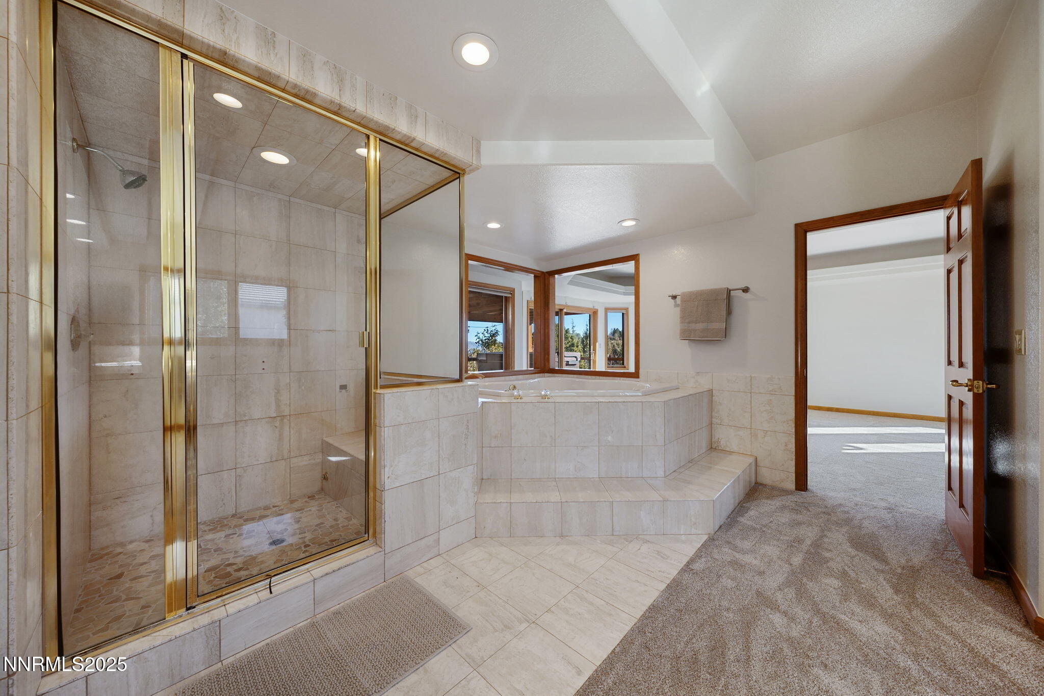 1205 Greensburg Circle Reno, NV 89509 - Photo 27 of 41 a bathroom with a glass shower door and a mirror