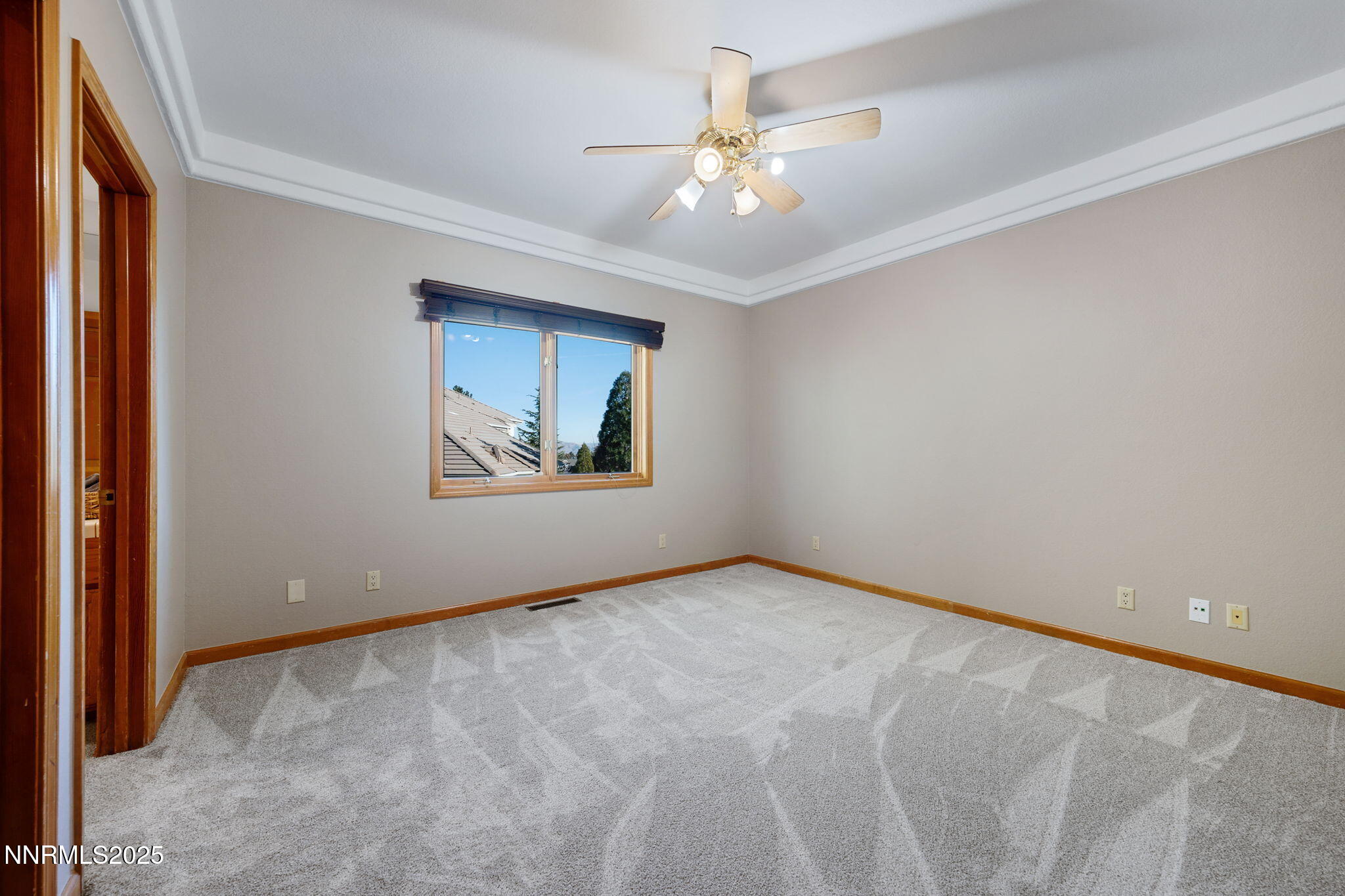 1205 Greensburg Circle Reno, NV 89509 - Photo 32 of 41 an empty room with a chandelier fan and windows