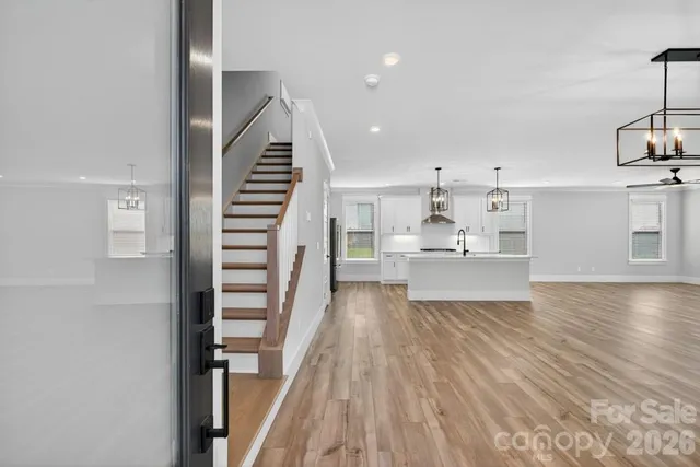 a view of a kitchen with wooden floor and a sink