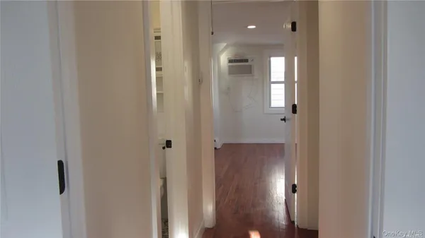 a view of a hallway with wooden floor