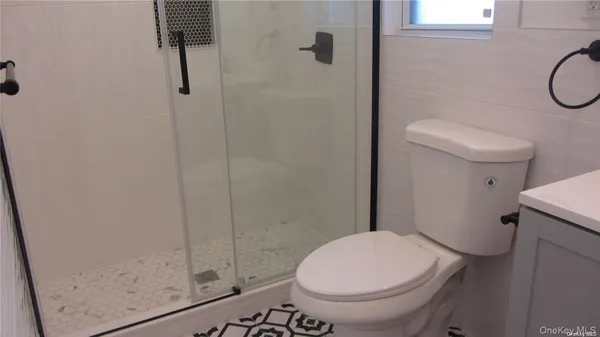 a bathroom with a toilet and a shower