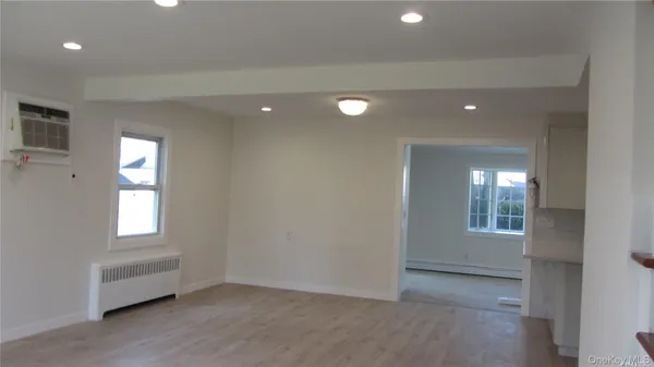 an empty room with windows and closet