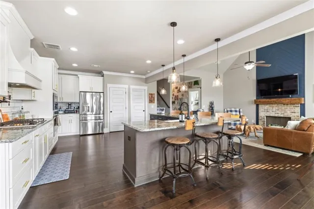a large kitchen with a table and chairs
