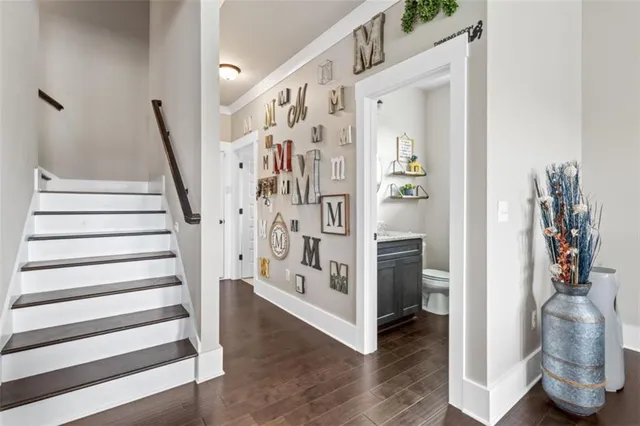 a view of a hallway with wooden floor and entryway
