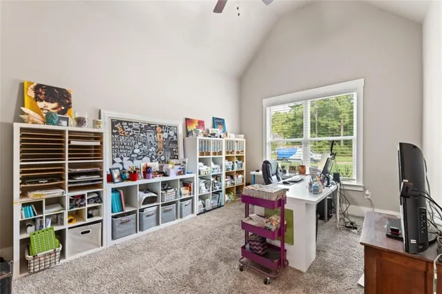 a view of a workspace with furniture and a window