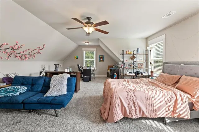 a bedroom with furniture and a large window