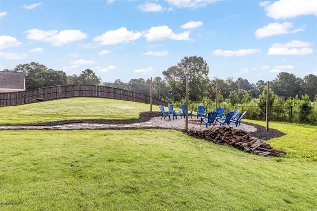 a view of a swimming pool with a yard and sitting area